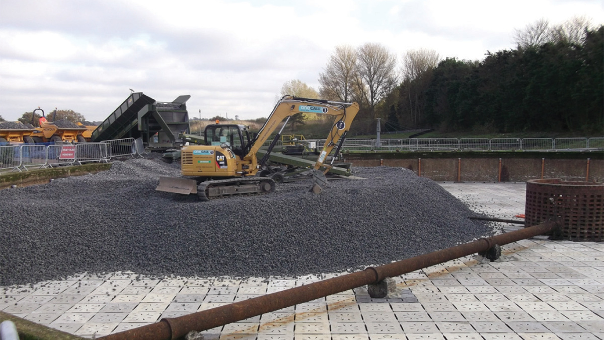 Placement of new filter media in newly tiled 42m dia biological filter using a conveyer system which greatly reduced the chances of damage through compaction by dump trucks - Courtesy of BTU