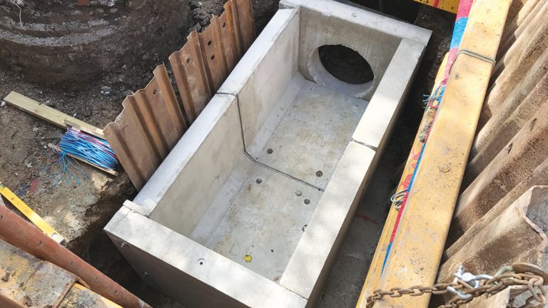 Precast overflow chamber unit installed adjacent to existing manhole - Courtesy of MMB