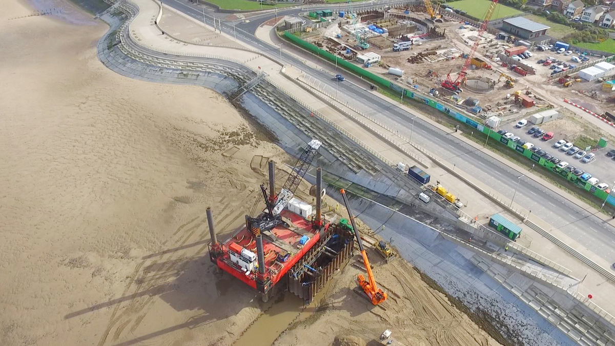 Aerial view of temporary marine cofferdam, jack-up barge, promenade and launch pit highlighting tunnelling route - Courtesy of UU