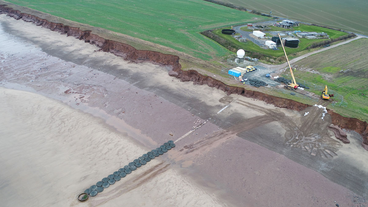 Aerial view of the temporary emergency protection works for existing LSO with the original Withernsea WwTW on the eroded clifftop - Courtesy of Royal HaskoningDHV