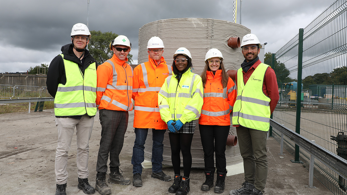 The project team in front of the 3D printed draw-pit - Courtesy of MMB