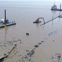 First section of pipe being positioned ahead of sinking into the pre-excavated trench - Courtesy of Kaymac Marine & Civil Engineering Ltd