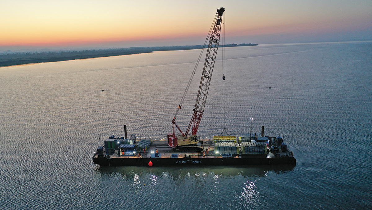 Concrete mattresses being place over submerged pipe during night shift - Courtesy of Kaymac Marine & Civil Engineering Ltd