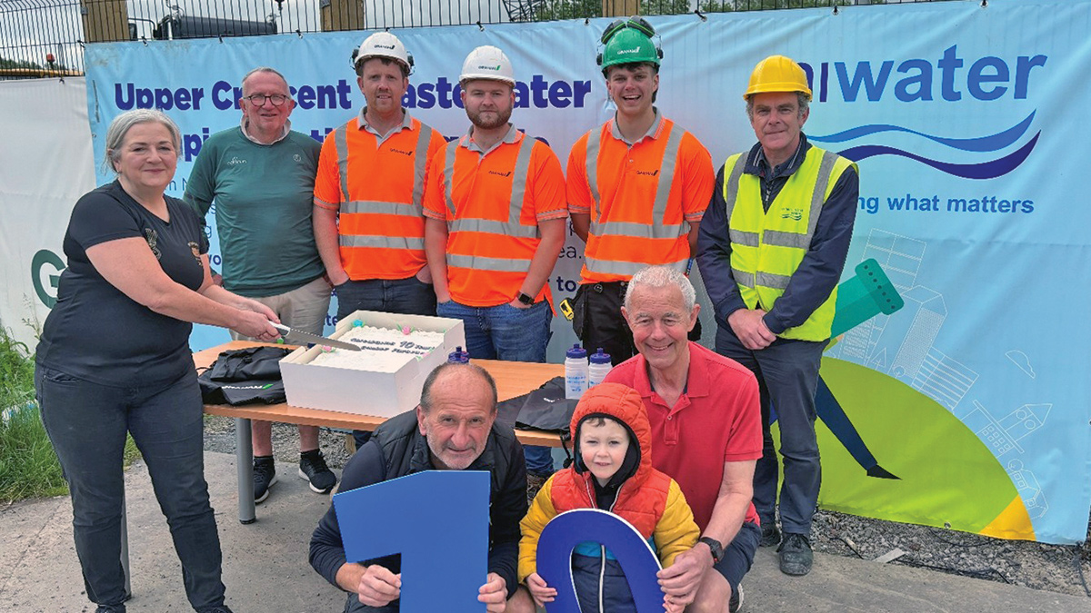 GRAHAM site team and NI Water presenting Park Run with anniversary cake and NI Water branded water bottles - Courtesy of NI Water