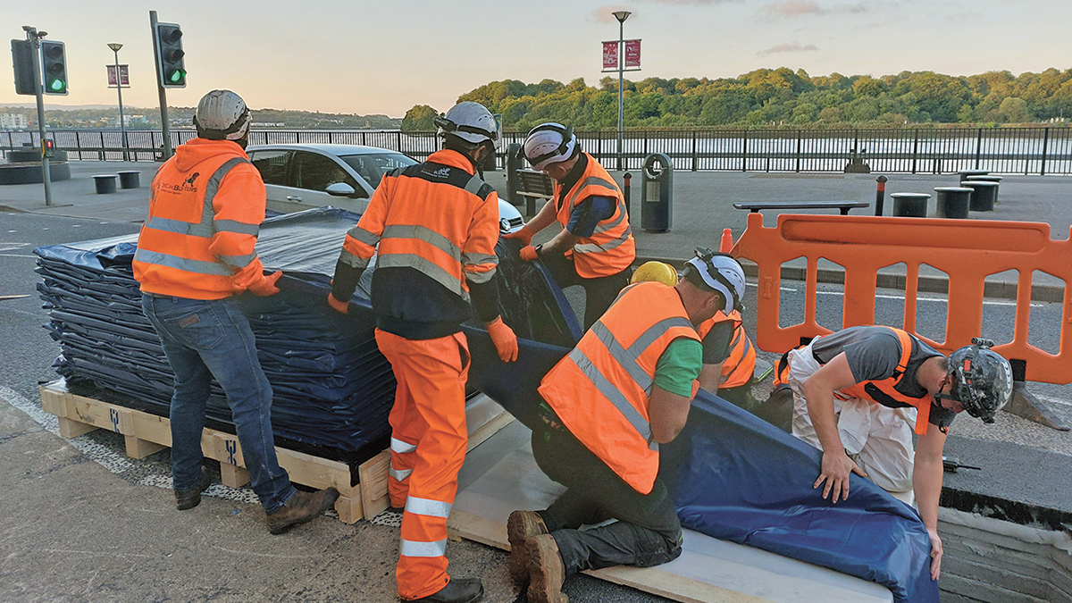 Folding of the CIPP liner to feed into manhole access - Courtesy of GRAHAM