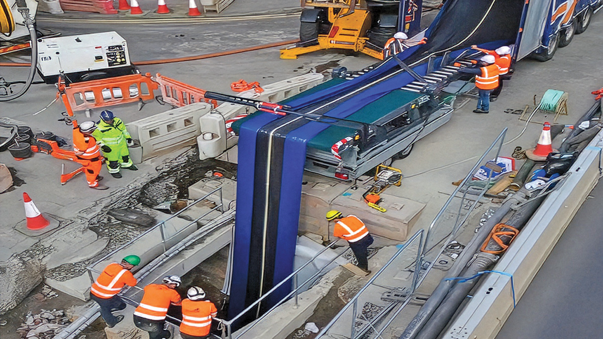 1,350mm liner being fed into manhole using folding table - Courtesy of GRAHAM