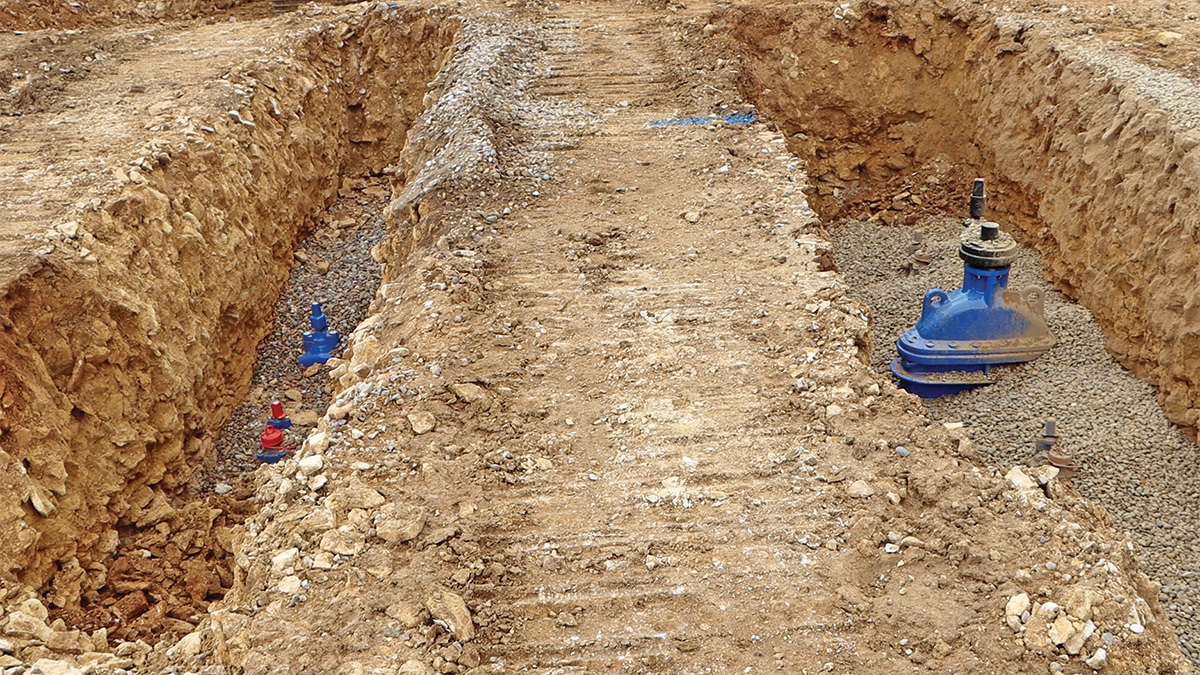 New valve fittings installed within an excavated trench, ready for connection and reinstatement - Courtesy of @one Alliance